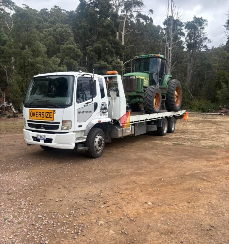 John Deere tractor on an oversize tilt tray truck