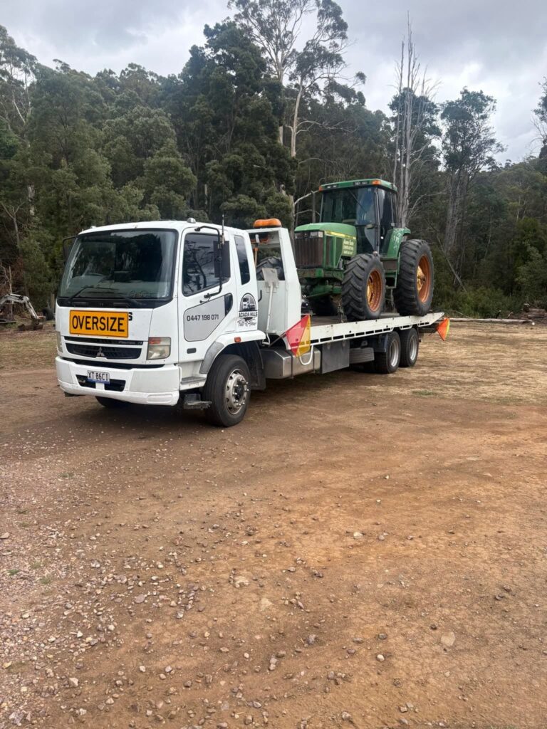 Acacia Hills Tilt n Tow truck transporting a tractor